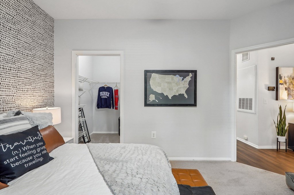 a bedroom with a bed and a closet and a map on the wall