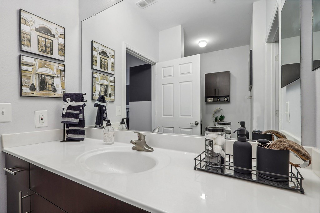 a large bathroom with a large sink and mirrors