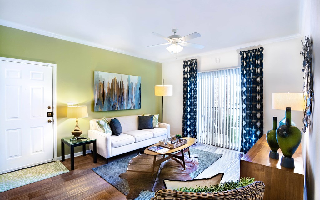 a living room with green walls and a white couch