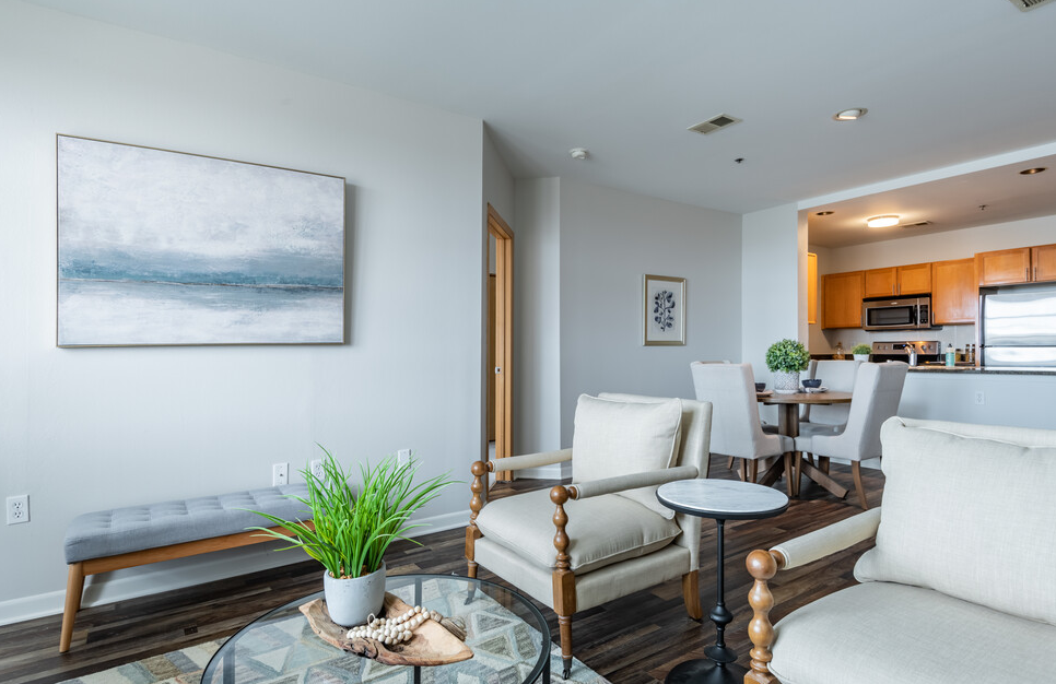a living room with grey walls and a glass coffee table