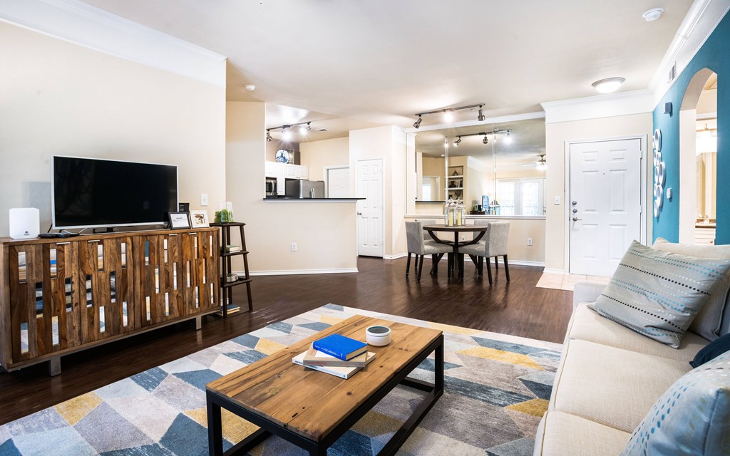a living room with a couch and a coffee table in front of a tv
