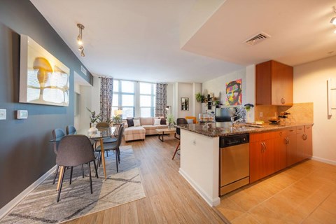 A kitchen with a dining table and chairs.