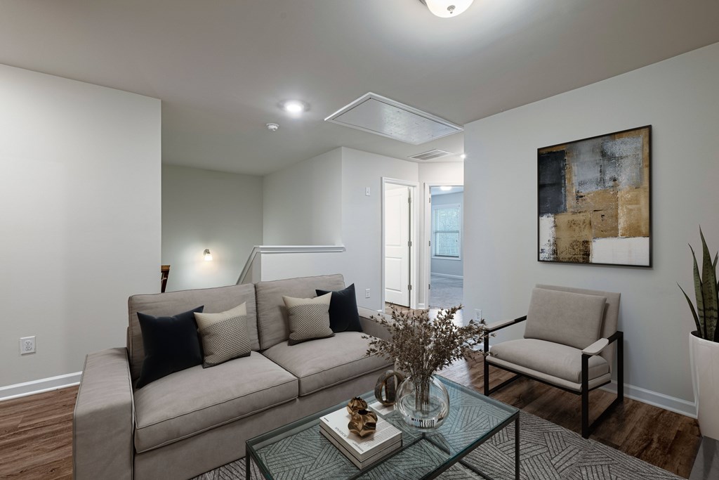 a living room with a couch and two chairs