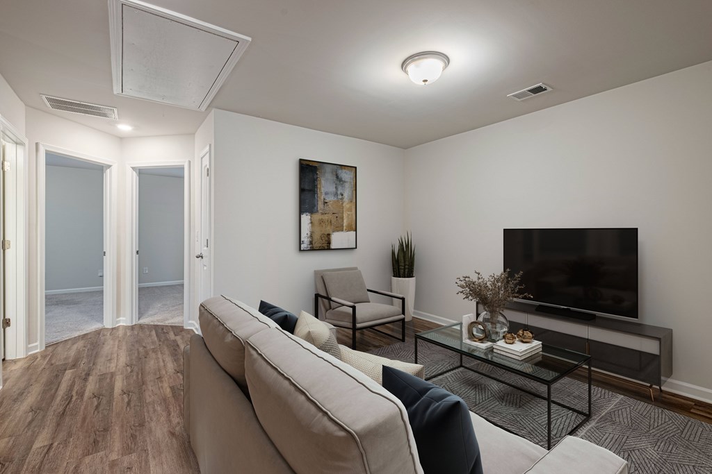 an open living room with a couch and a tv