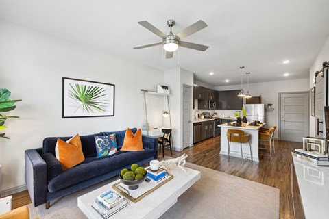 A living room with a dark blue couch and a white coffee table.