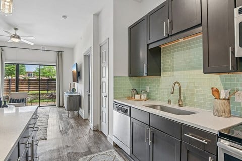 A modern kitchen with dark wood cabinets and a white countertop.