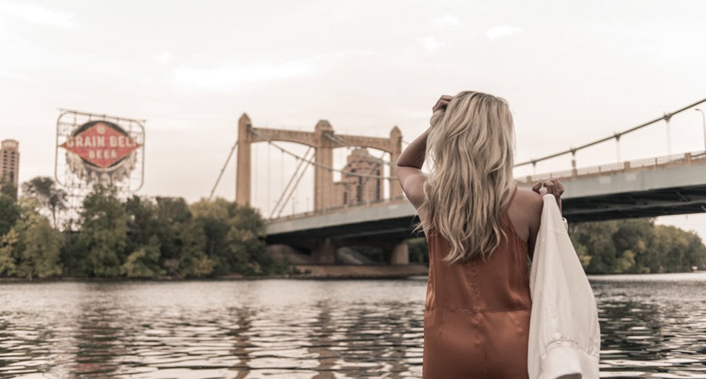 woman outlooking bridge over river