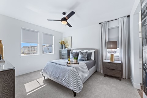 large bedroom with natural lighting and ceiling fan