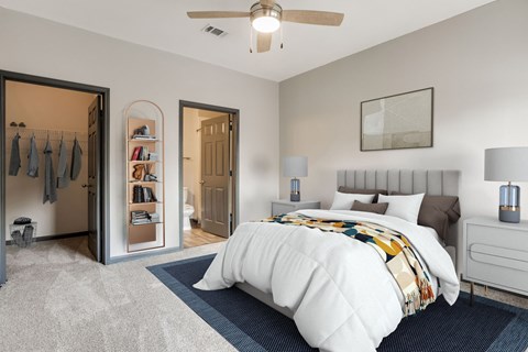A bedroom with a large bed and a ceiling fan.