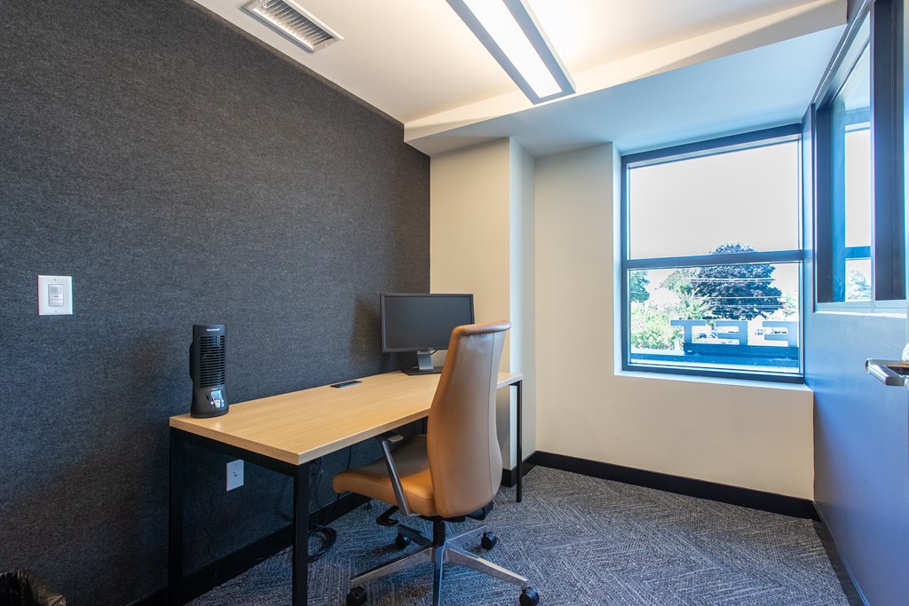 a workspace with a computer monitor and chair
