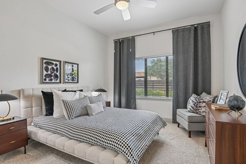 Markethaus 3700 A bedroom with a bed, nightstand, and a window with curtains.