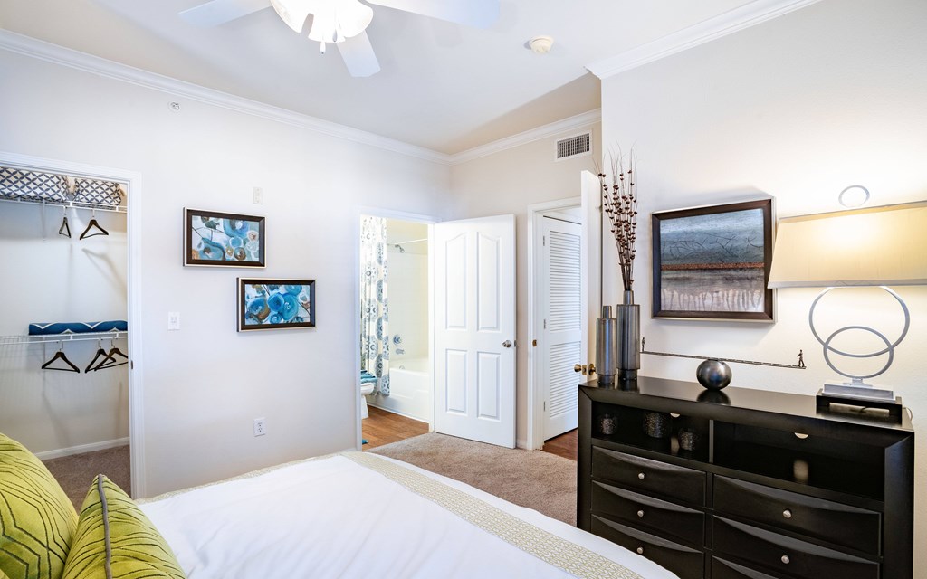 a bedroom with a bed and a dresser