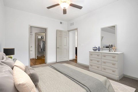 a bedroom with a large bed and a ceiling fan