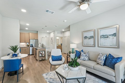 A modern living room with a blue chair and a white couch.