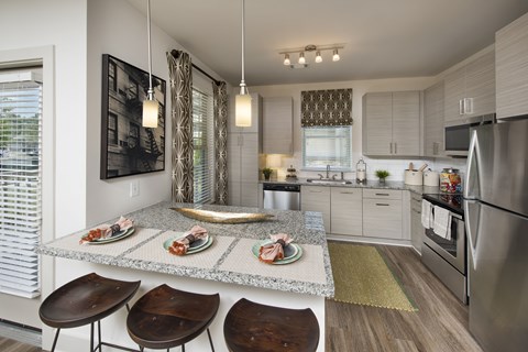 A modern kitchen with a dining table and chairs.
