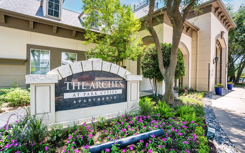 a building with a sign that says the arches at park cities apartments