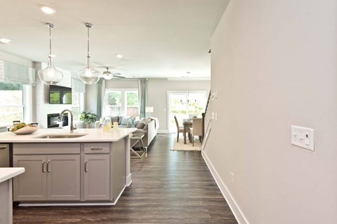 A modern kitchen with a long counter and a sink.