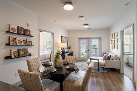 A dining room with a table set for six.