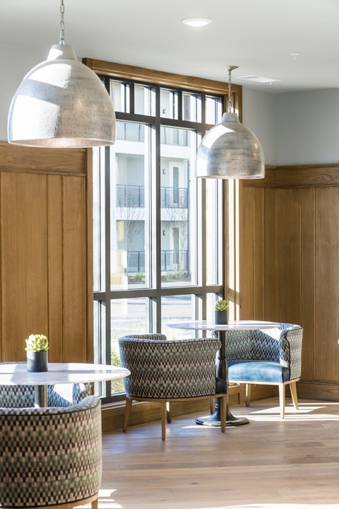 A dining area with a round table and chairs.
