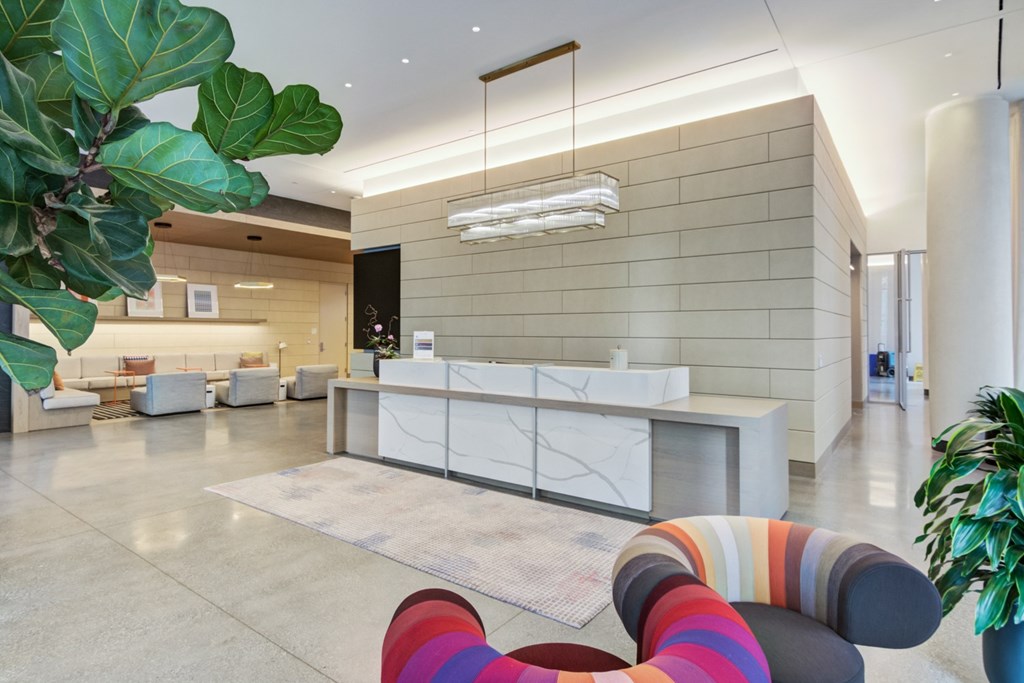 Lobby with grand concierge desk and dual seating areas with soft seating