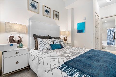 a bedroom with a white bed and a blue blanket