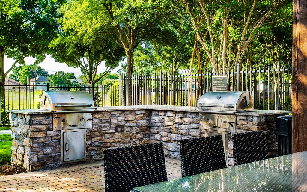 two bbq grills and a table and chairs