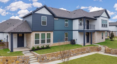 A house with a grey roof and a blue door.