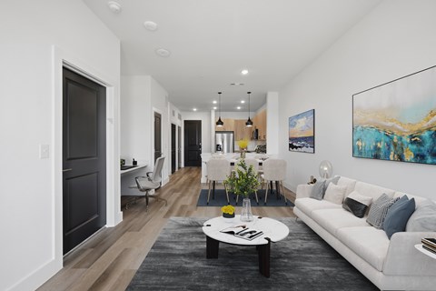 A modern living room with a white sofa and a coffee table.