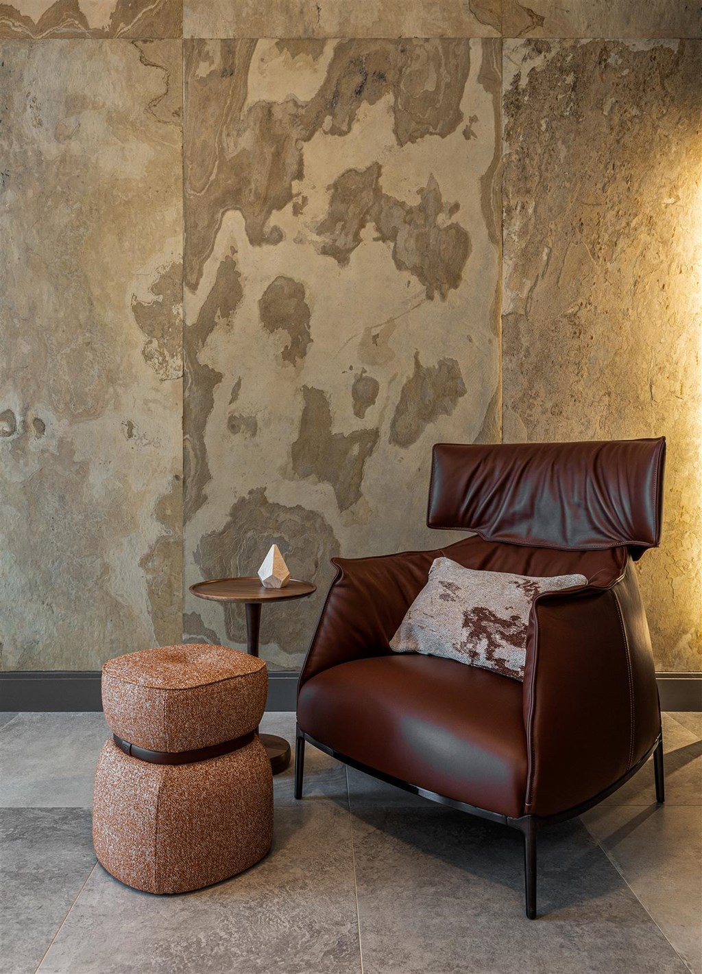 a leather chair and in front of a wall