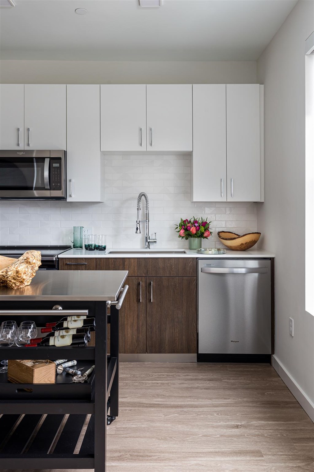 a kitchen with white cabinets and stainless steel appliances