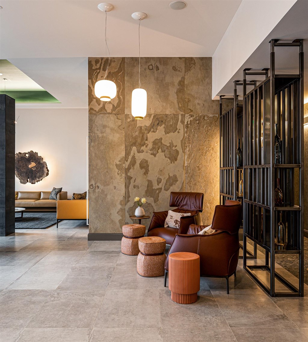 a living room with a brown couch and stools