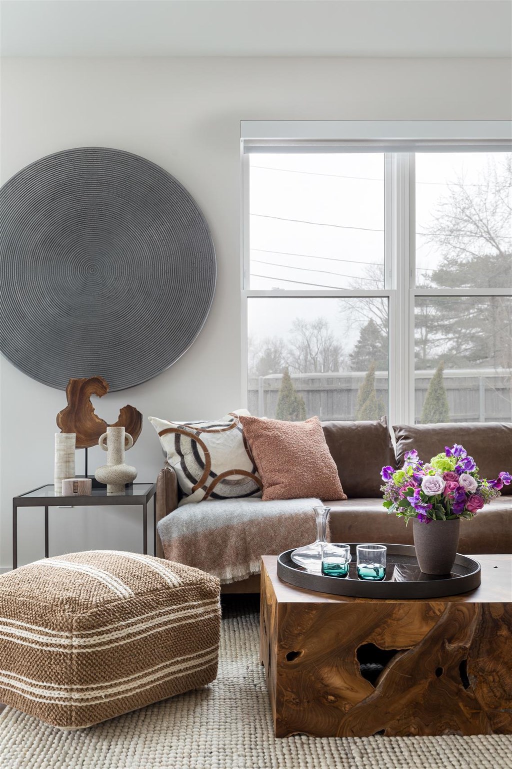 a living room with a couch and a table and a window