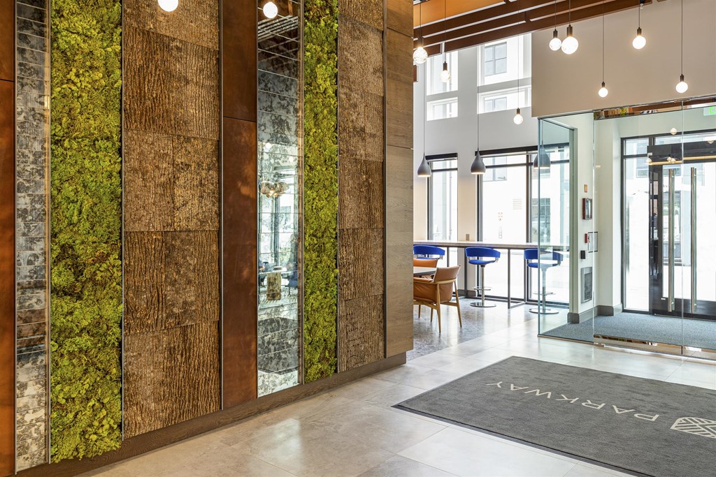 a view of the lobby of a building with plants on the wall