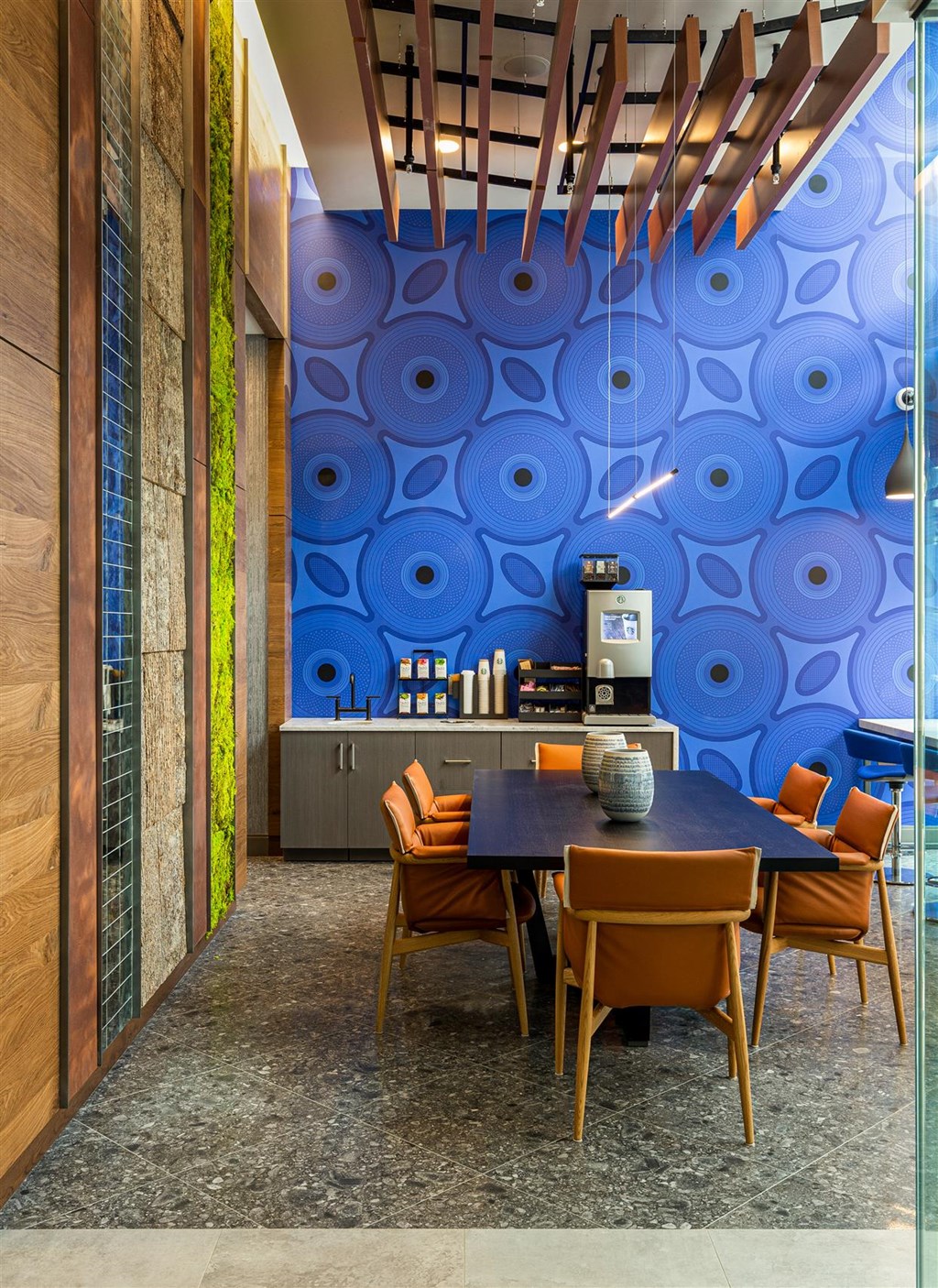 a dining room with a blue wall and a table and chairs