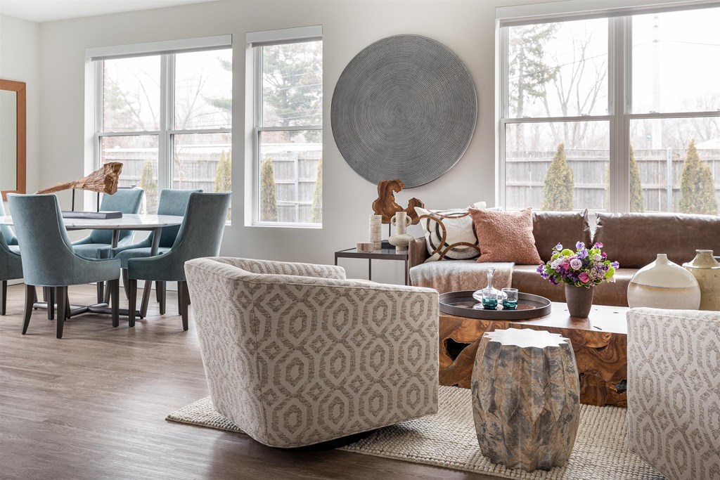 a living room with a couch and chairs and a table
