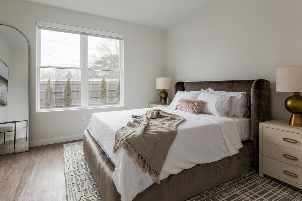 a bedroom with a large bed and a large window