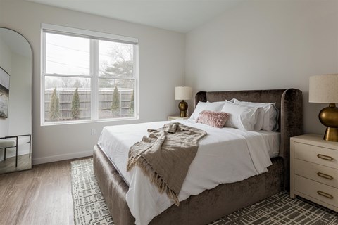 a bedroom with a large bed and a large window