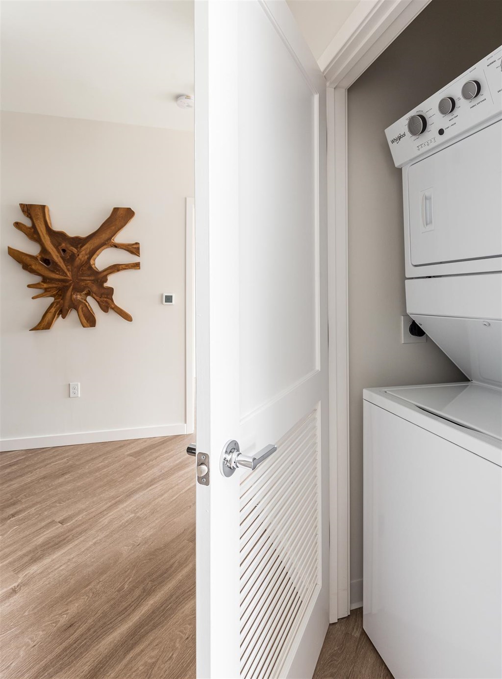 a white washer and dryer in a room with a white door