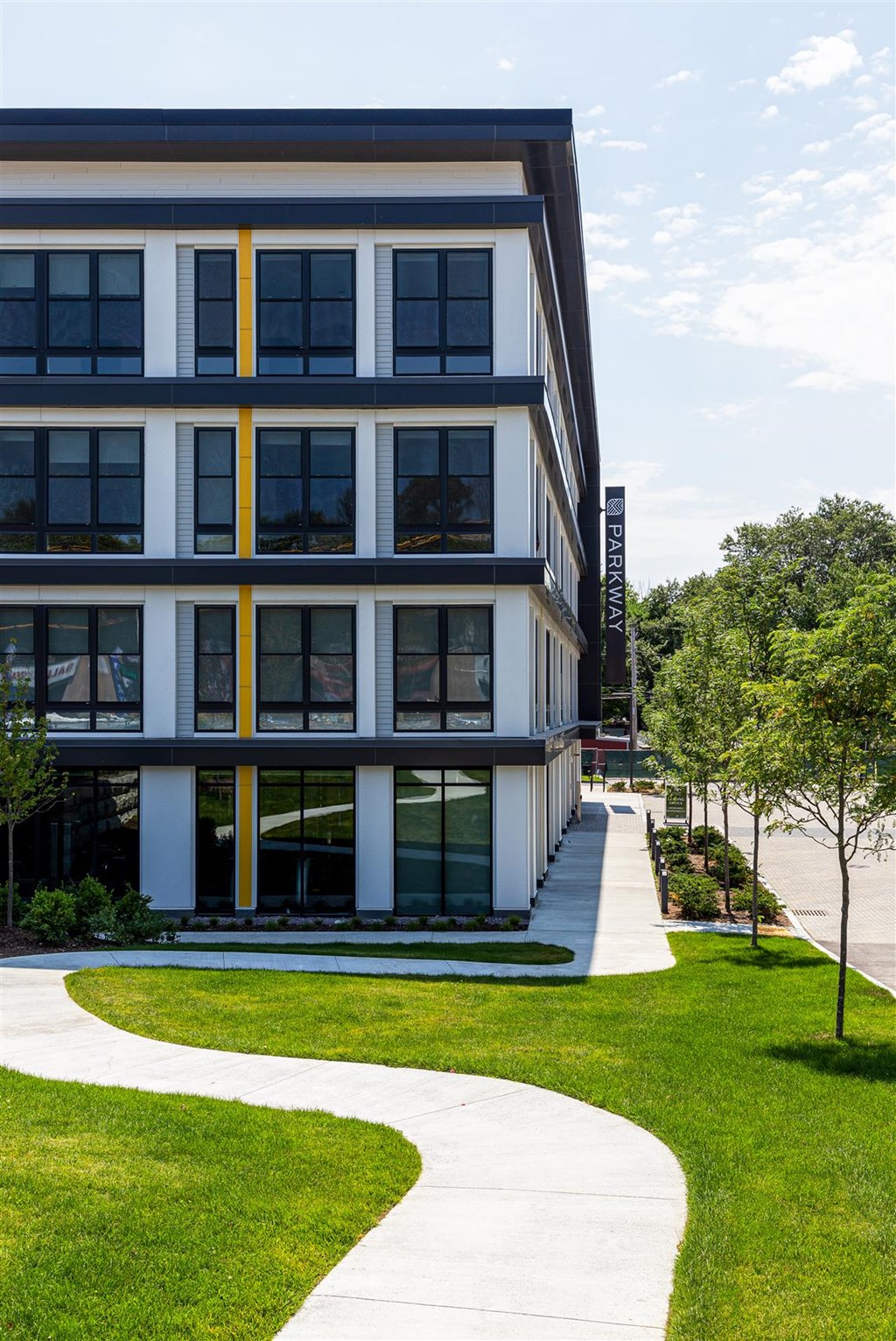 a modern building with a sidewalk in front of it