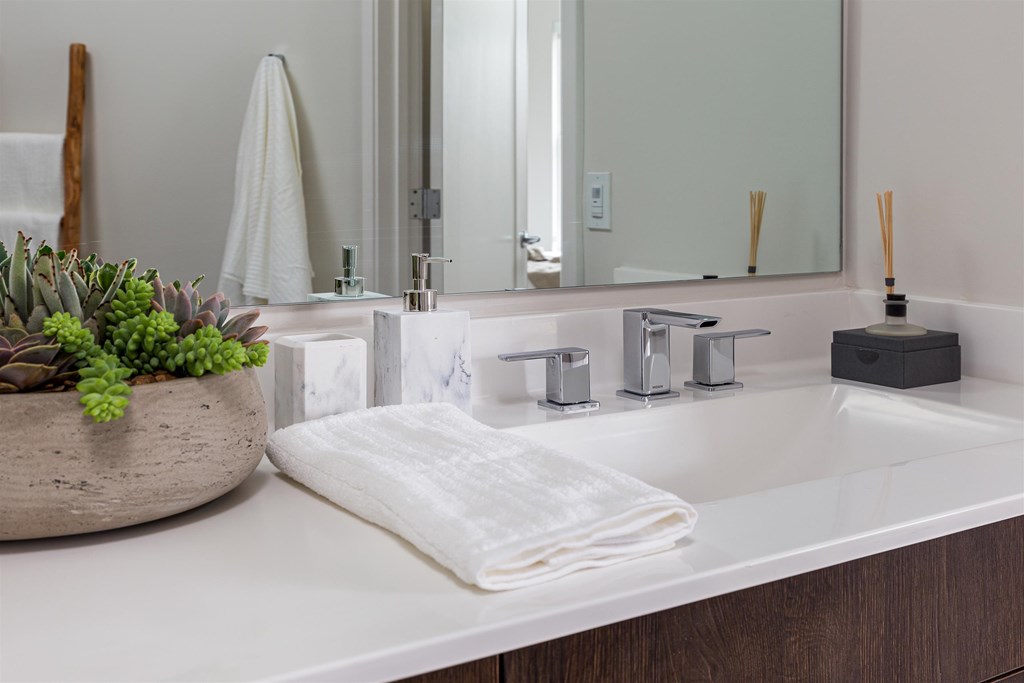 a bathroom with a white sink and a mirror