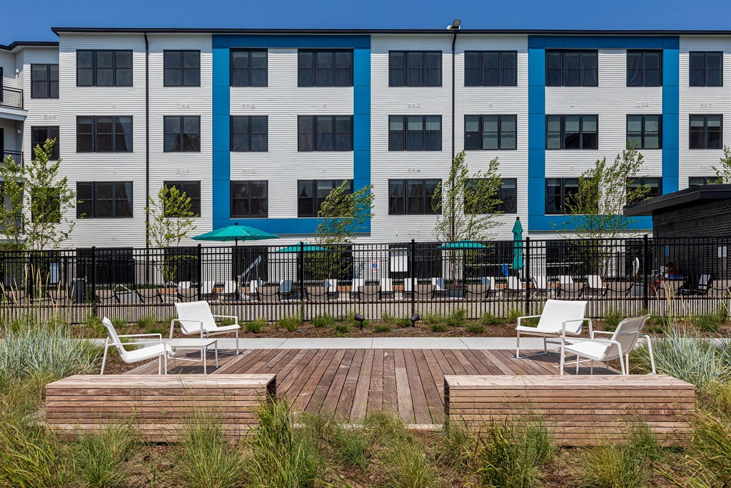 a patio with two chairs in front of a building