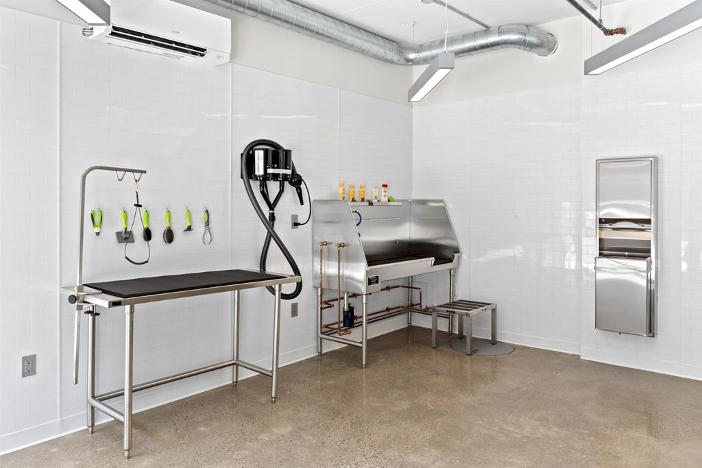 a laundry room with a sink and a ironing board