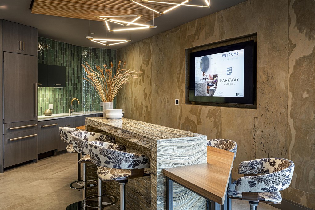 a dining room with a table and chairs and a tv on the wall