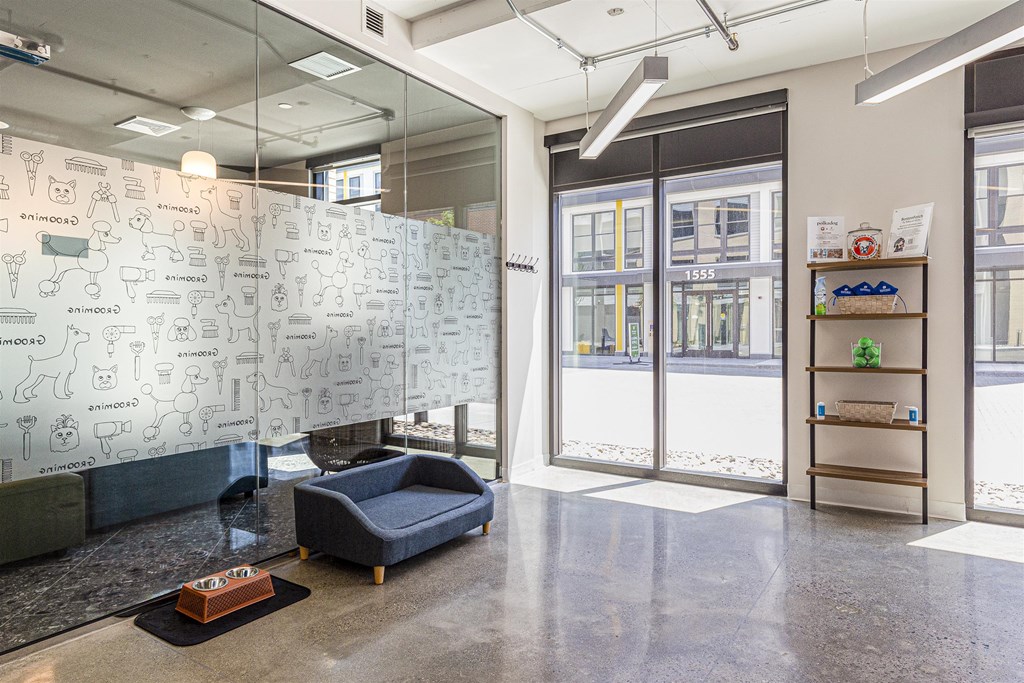 a whiteboard wall in a lobby of a building with glass doors