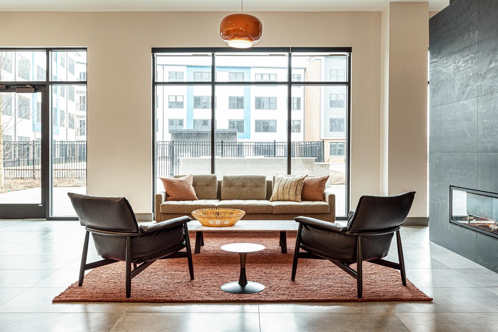a living room with a couch and chairs and a coffee table