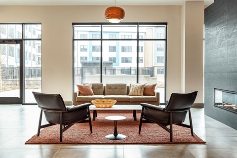 A living room with a couch, two chairs and a coffee table.