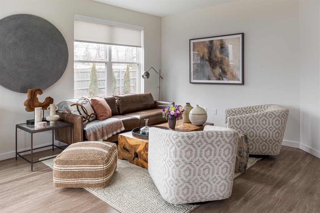 a living room with a couch and chairs and a table