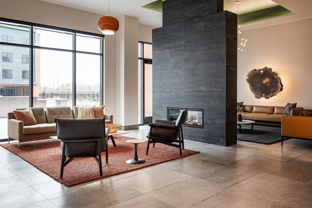 a living room with couches chairs and a fireplace