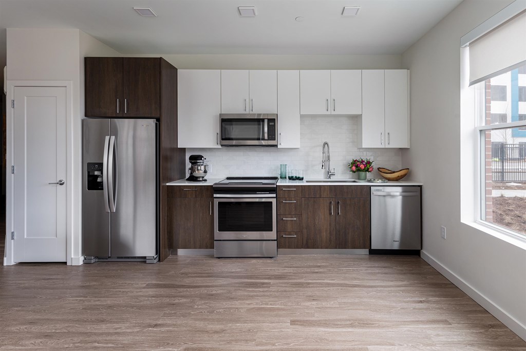 a kitchen with stainless steel appliances and white cabinets
