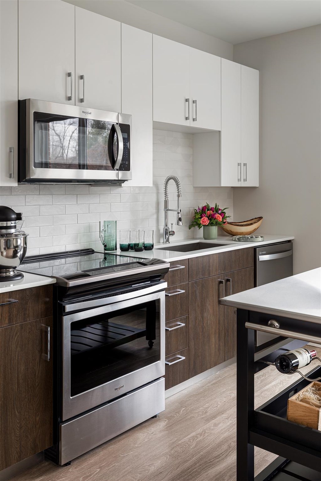 a modern kitchen with stainless steel appliances and white cabinets